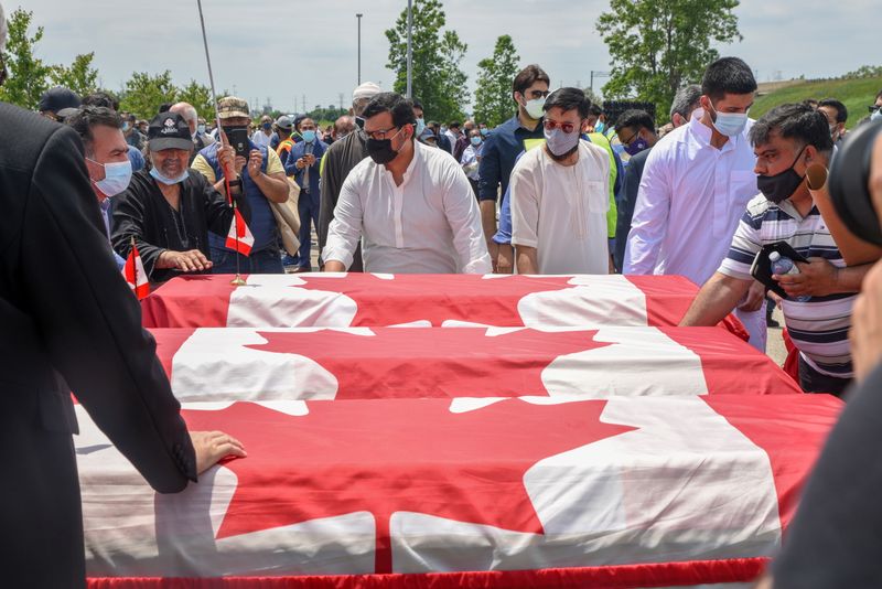 &copy; Reuters. FILE PHOTO: People transport three flag-wrapped coffins at the funeral of the Afzaal family that was killed in what police describe as a hate-motivated attack, at the Islamic Centre of Southwest Ontario, in London, Ontario, Canada June 12, 2021. REUTERS/A
