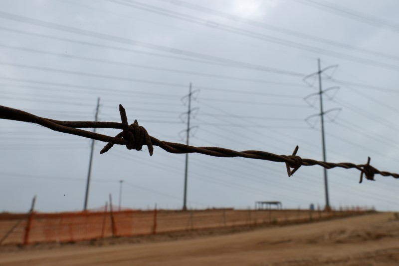 &copy; Reuters. FILE PHOTO: A barbed-wire fence runs parallel to power power lines as California consumers prepare for more possible outages following weekend outages to reduce system strain during a brutal heat wave amid the outbreak of coronavirus disease (COVID-19) in