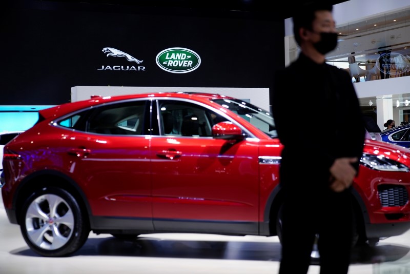 &copy; Reuters. FILE PHOTO: A staff member stands at the Jaguar Land Rover booth during a media day for the Auto Shanghai show in Shanghai, China April 20, 2021. REUTERS/Aly Song