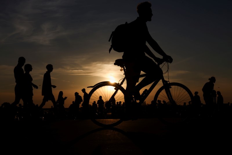 &copy; Reuters. FILE PHOTO: A person rides a bike at the Tempelhofer Feld, as the spread of the coronavirus disease (COVID-19) continues, in Berlin, Germany, May 9, 2021. REUTERS/Christian Mang/File Photo