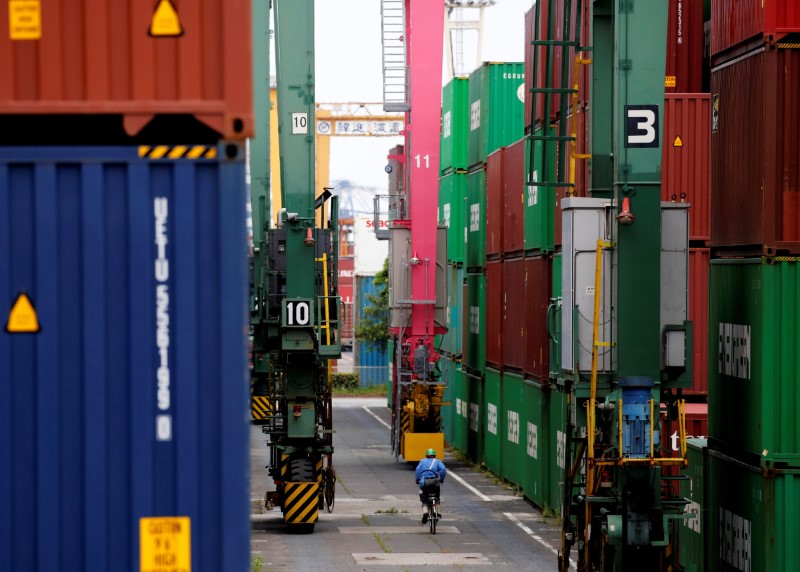 &copy; Reuters. FILE PHOTO: A man in a bicycle drives past containers at an industrial port in Tokyo, Japan, May 22, 2019. REUTERS/Kim Kyung-Hoon