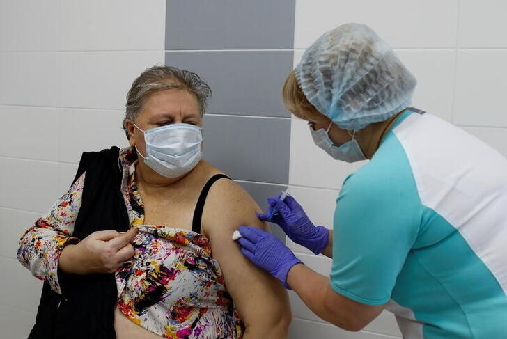&copy; Reuters. A school teacher receives a jab while being injected with Sputnik V (Gam-COVID-Vac) vaccine against the coronavirus disease (COVID-19) at a clinic in the town of Domodedovo near Moscow, Russia December 3, 2020. REUTERS/Maxim Shemetov