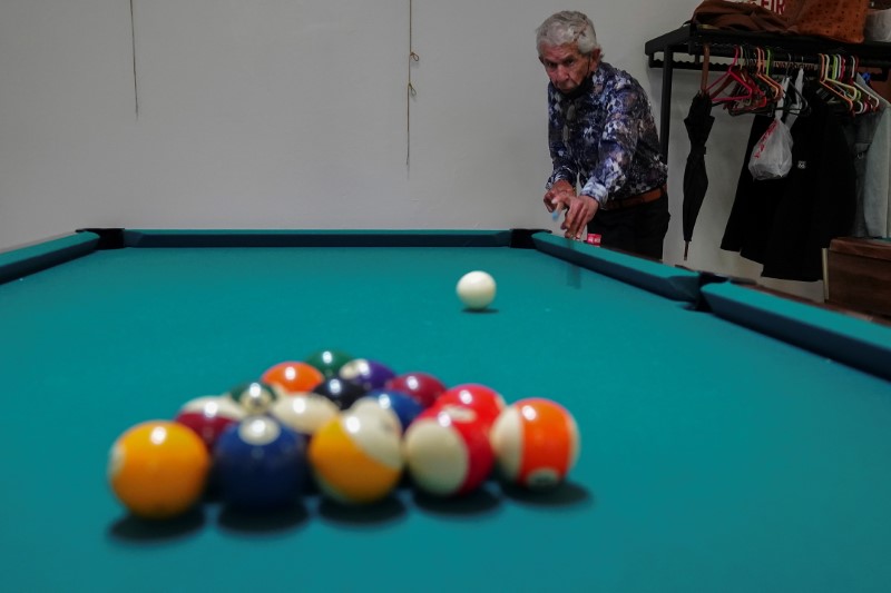 &copy; Reuters. A man shoots the cue ball to break as he plays billiards at the S.T.A.R. Senior Center in New York City, New York, U.S., June 14, 2021. REUTERS/Carlo Allegri