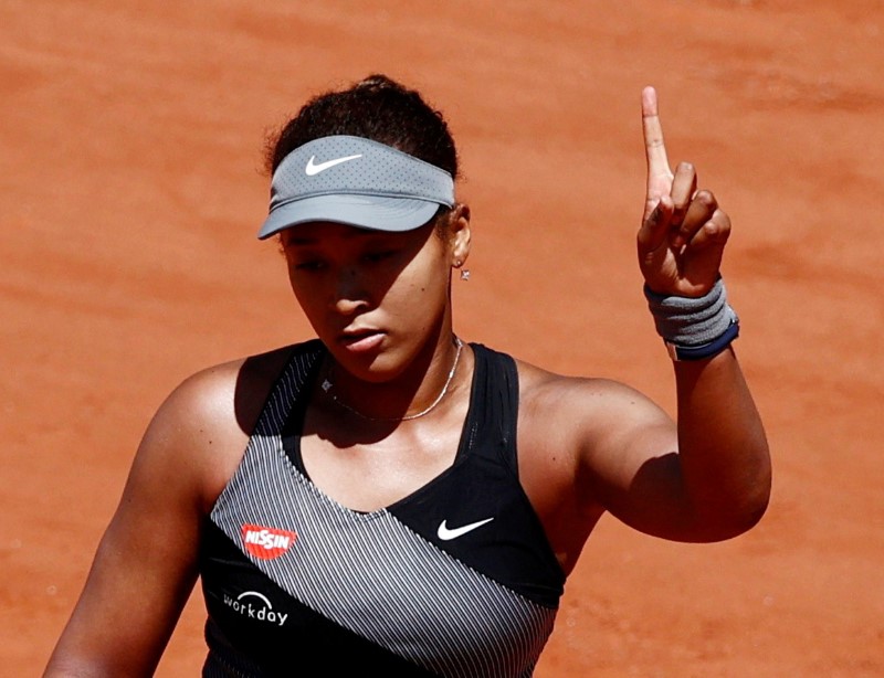 &copy; Reuters. FILE PHOTO: Roland Garros, Paris, France - May 30, 2021 Picture taken May 30, 2021 Japan's Naomi Osaka reacts during her first round match against Romania's Patricia Maria Tig REUTERS/Christian Hartmann/File Photo