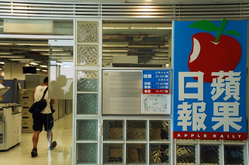 &copy; Reuters. An employee walks at the offices of Apple Daily and Next Media after police raided the newsroom, in Hong Kong, China June 17, 2021. REUTERS/Lam Yik