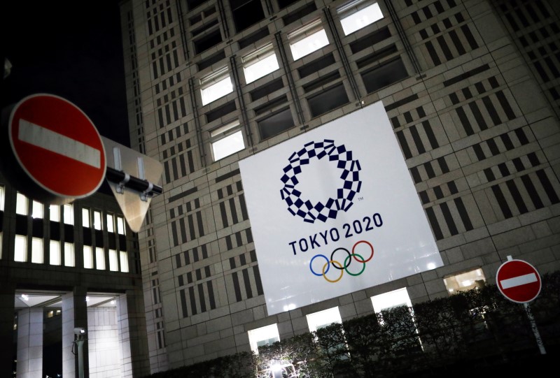 &copy; Reuters. The logo of Tokyo 2020 Olympic Games that have been postponed to 2021 due to the coronavirus disease (COVID-19) outbreak, is seen through signboards, at Tokyo Metropolitan Government Office building in Tokyo, Japan January 22, 2021. REUTERS/Issei Kato