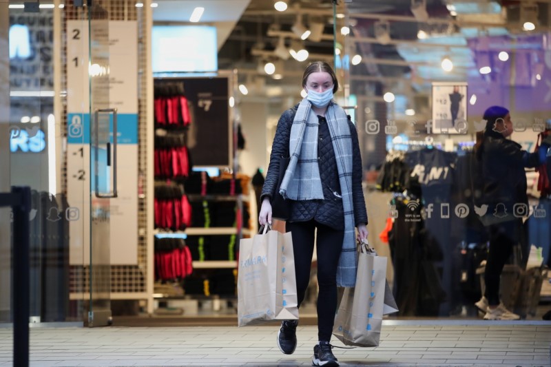&copy; Reuters. FILE PHOTO:  A customer leaves with shoping bags, as retail store Primark in Birmingham, Britain reopens its doors after a third lockdown imposed in early January due to the ongoing coronavirus disease (COVID-19) pandemic, April 12, 2021. REUTERS/Carl Rec