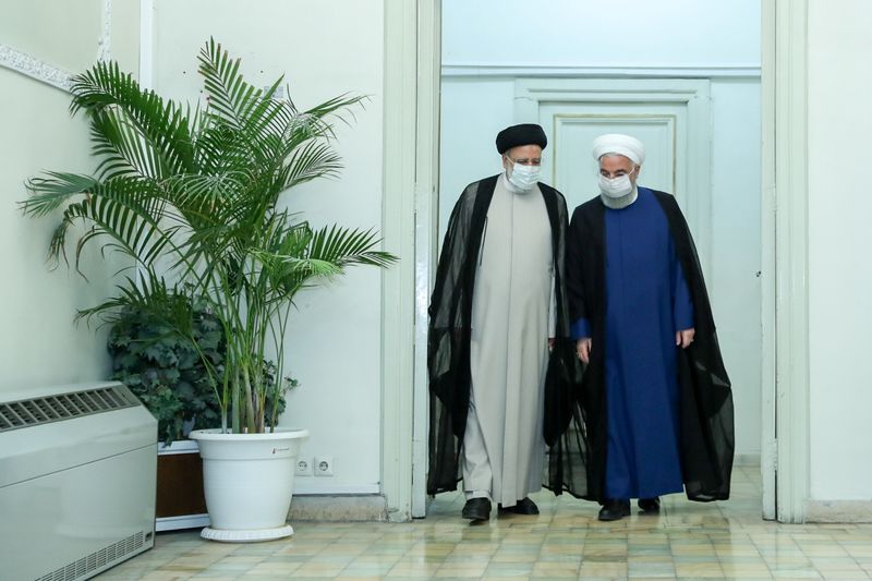 © Reuters. Iran's outgoing President Hassan Rouhani meets with Iran's President-elect Ebrahim Raisi in Tehran, Iran June 19, 2021. Official Presidential website/Handout via REUTERS