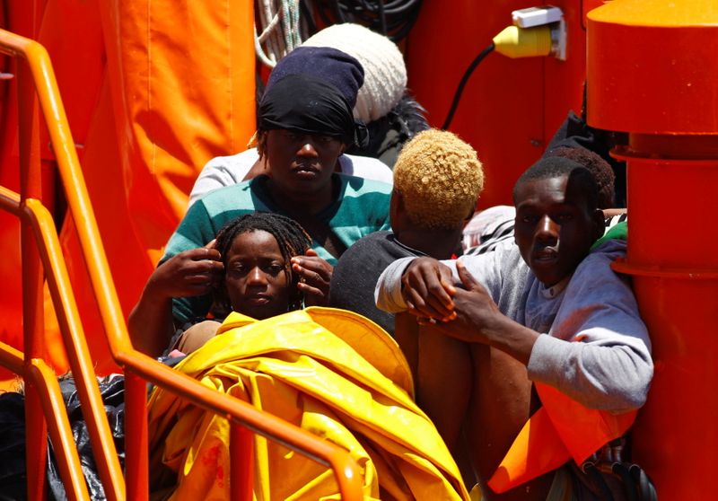 &copy; Reuters. Migrants wait to disembark from a Spanish coast guard vessel, in the port of Arguineguin, on the island of Gran Canaria, Spain June 20, 2021. REUTERS/Borja Suarez