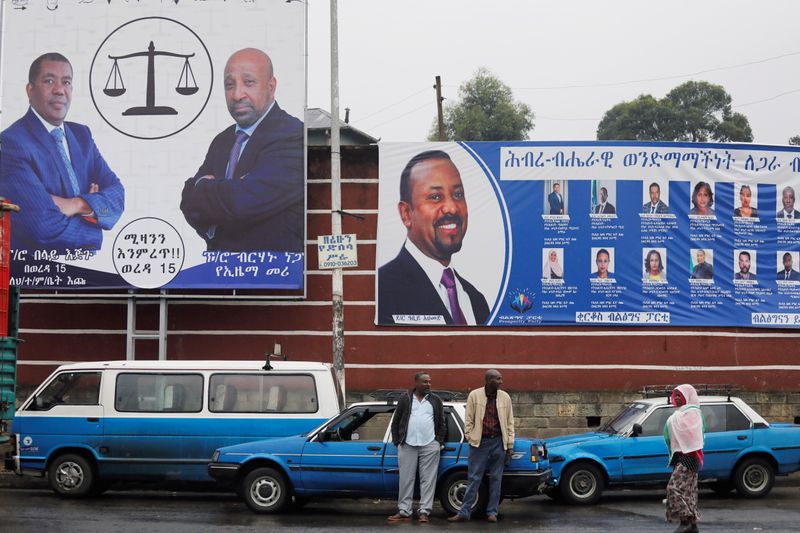 &copy; Reuters. Taxi drivers stand in front of campaign banners of the Ethiopian Prime Minister Abiy Ahmed, and Birhanu Nega, head of the Ethiopian Citizens for Social Justice party, hours before Ethiopia's parliamentary and regional elections, in Addis Ababa, Ethiopia, 