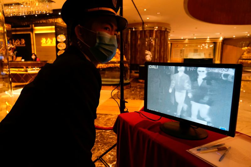 &copy; Reuters. FILE PHOTO: A security guard monitors thermal scanners that detect temperatures of visitors at the closed Grand Lisboa casino and hotel, following the coronavirus outbreak in Macau, China February 5, 2020. REUTERS/Tyrone Siu/File Photo