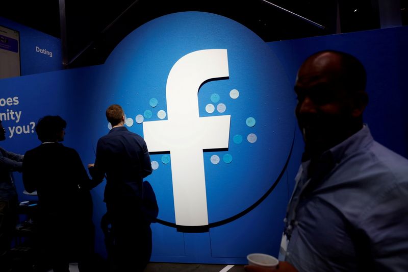 &copy; Reuters. FILE PHOTO: Attendees walk past a Facebook logo during Facebook Inc's F8 developers conference in San Jose, California, U.S., April 30, 2019.  REUTERS/Stephen Lam/File Photo