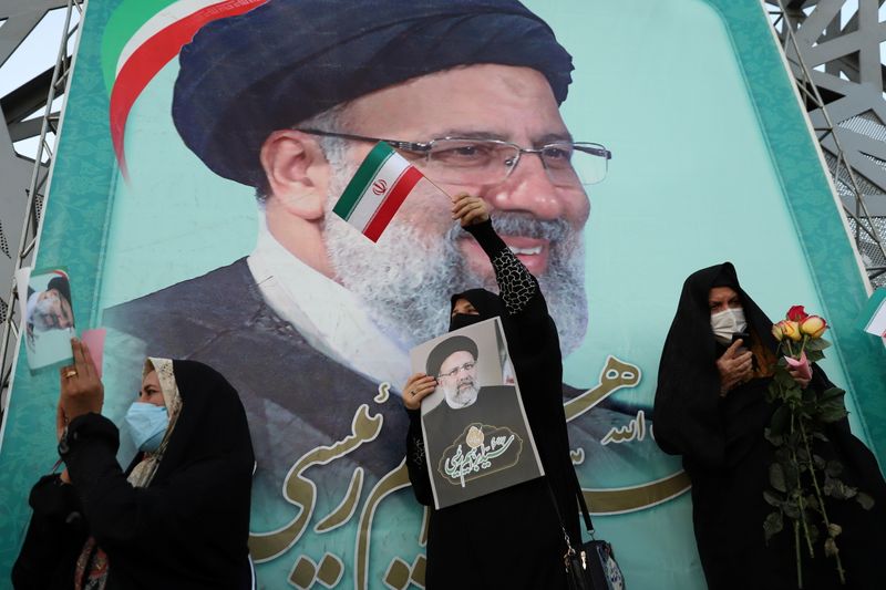&copy; Reuters. FILE PHOTO: A supporter of Ebrahim Raisi displays his portrait during a celebratory rally for his presidential election victory in Tehran, Iran June 19, 2021. Majid Asgaripour/WANA (West Asia News Agency) via REUTERS 