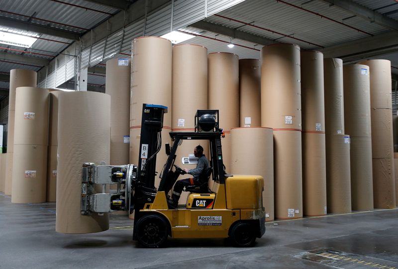 &copy; Reuters. FILE PHOTO: An employee transports a giant reel of paper at the carboard box manufacturing company DS Smith Packaging Atlantique in La Chevroliere, near Nantes, France, April 25, 2019. REUTERS/Stephane Mahe/File Photo