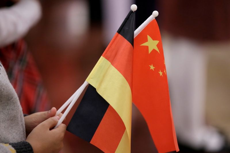 &copy; Reuters. FILE PHOTO: A student holds flags of China and Germany before a welcome ceremony hosted by China's President Xi Jinping for German President Frank-Walter Steinmeier at the Great Hall of the People in Beijing, China December 10, 2018. REUTERS/Jason Lee/Fil