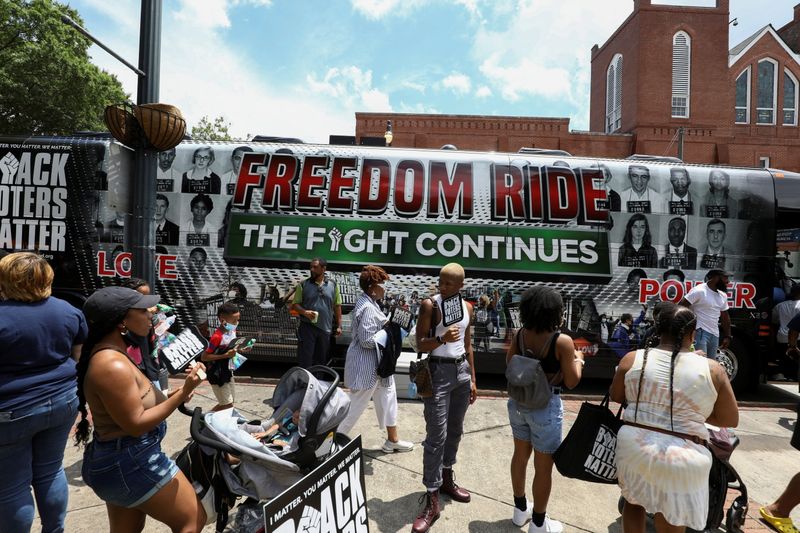 &copy; Reuters. People gather in front of one of the tour buses during a stop on the Freedom Ride For Voting Rights at Ebenezer Baptist Church in Atlanta, Georgia, U.S. June 21, 2021.  REUTERS/Dustin Chambers