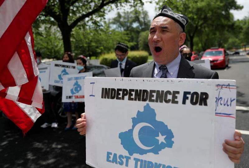 &copy; Reuters. FILE PHOTO: Demonstrators, including Aziz Sulayman, hold a protest in front of the U.S. State Department to commemorate Uyghur Doppa Day and to urge the U.S. and the international community to take action against China's treatment of the Uyghur people in 