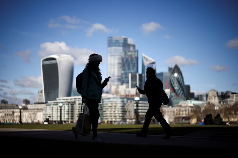 &copy; Reuters. FILE PHOTO: The City of London financial district can be seen as people walk along the south side of the River Thames, amid the coronavirus disease (COVID-19) outbreak in London, Britain, March 19, 2021. REUTERS/Henry Nicholls/File Photo