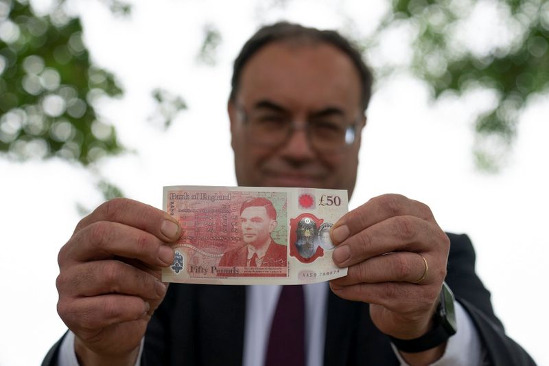&copy; Reuters. Bank of England Governor Andrew Bailey holds the new £50 note, which features Alan Turing, at Bletchley Park in Milton Keynes, Britain, June 21, 2021. Picture taken June 21, 2021. Joe Giddens/Pool via REUTERS
