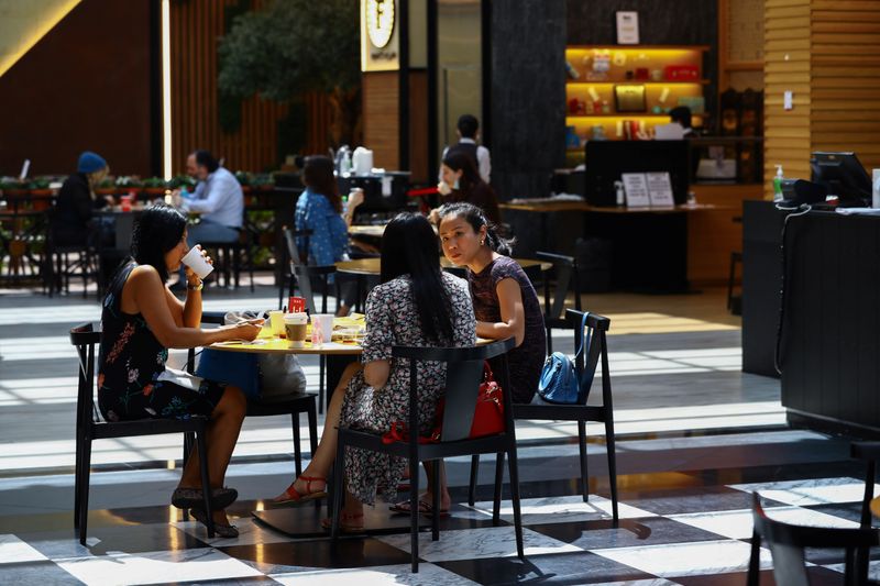 &copy; Reuters. People sit in a coffee shop during the reopening of malls, following the outbreak of the coronavirus disease (COVID-19), at Mall of the Emirates in Dubai, United Arab Emirates, May 28, 2020. REUTERS/Ahmed Jadallah/Files