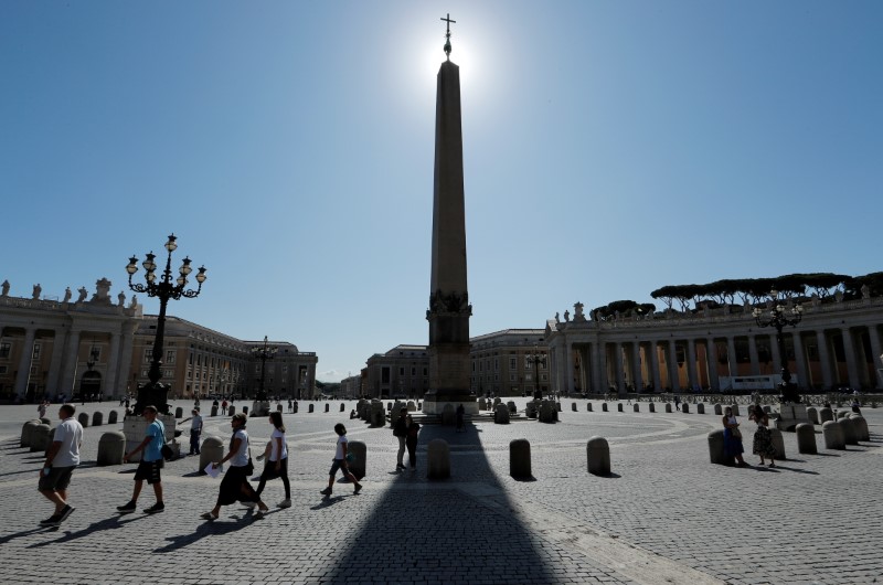 &copy; Reuters. FILE PHOTO: People walk on St. Peter's Square as Pope Francis gives his weekly general audience. at the Vatican, August 5, 2020. REUTERS/Remo Casilli/File Photo