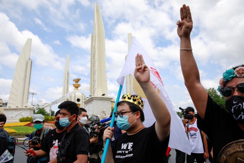 &copy; Reuters. Protest leader Parit "Penguin" Chiwarak (with crown) shows the three-finger salute during a demonstration to mark the 89th anniversary of the abolition of absolute monarchy in Bangkok, Thailand, June 24, 2021. REUTERS/Soe Zeya Tun