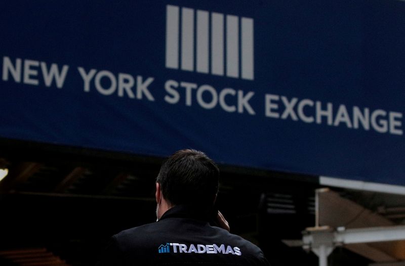 &copy; Reuters. FILE PHOTO: A trader talks on his phone on Wall St. outside the New York Stock Exchange (NYSE) in New York, U.S., January 15, 2021. REUTERS/Brendan McDermid/File Photo