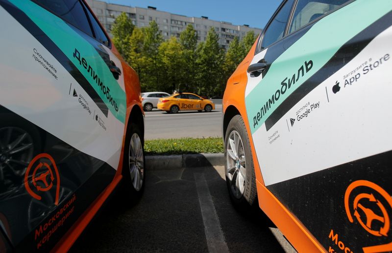 &copy; Reuters. FILE PHOTO: A taxi car drives by Delimobil branded vehicles in Moscow, Russia May 20, 2020. REUTERS/Maxim Shemetov
