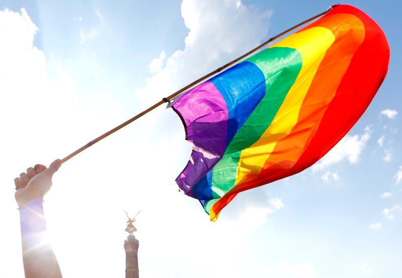 &copy; Reuters. FOTO DE ARCHIVO: Una persona sostiene una bandera arcoíris frente a la Columna de la Victoria de Berlín durante el desfile anual del Orgullo Gay, también llamado desfile del Día de la Calle Cristóbal (CSD), en Berlín, Alemania el 28 de julio de 2018