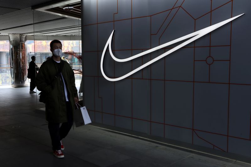 &copy; Reuters. FILE PHOTO: A man walks past a store of the sporting goods retailer Nike Inc at a shopping complex in Beijing, China March 25, 2021. REUTERS/Florence Lo/File Photo