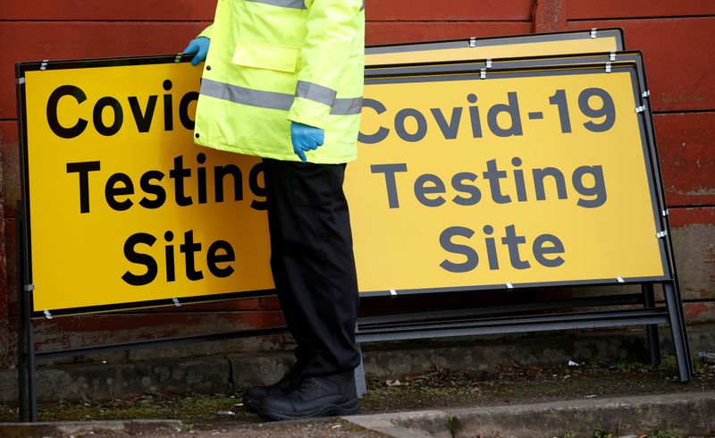&copy; Reuters. FILE PHOTO: A member of NHS Test and Trace staff sets up a mobile testing centre amid the outbreak of the coronavirus disease (COVID-19) in the Moston area of Manchester, Britain, February 17, 2021. REUTERS/Phil Noble/File Photo