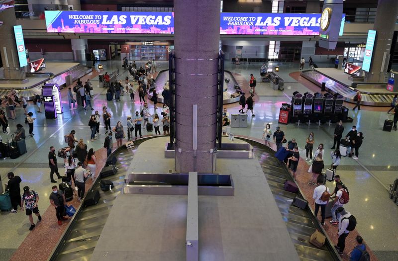 © Reuters. FILE PHOTO: Travelers wait for luggage as they flock to Las Vegas ahead of Memorial Day weekend at McCarran International Airport in Las Vegas, Nevada, U.S., May 28, 2021.  REUTERS/Bridget Bennett