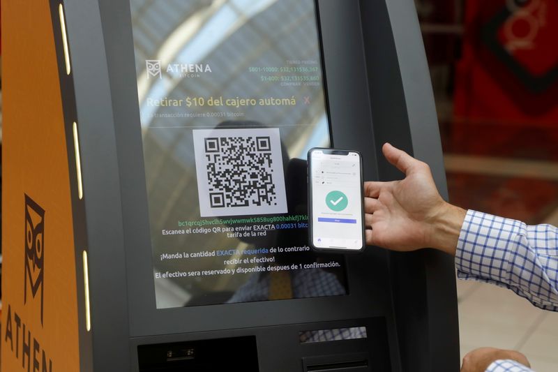 &copy; Reuters. Eric Gravengaard, CEO of Athena Bitcoin Inc. shows the use of a Bitcoin ATM during a presentation ahead of a news conference   in San Salvador, El Salvador June 24, 2021. REUTERS/Jose Cabezas