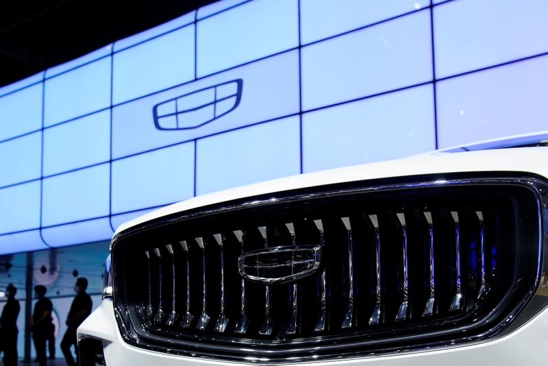 &copy; Reuters. The Geely logo is seen on its vehicle during a media day for the Auto Shanghai show in Shanghai, China April 19, 2021. REUTERS/Aly Song/Files