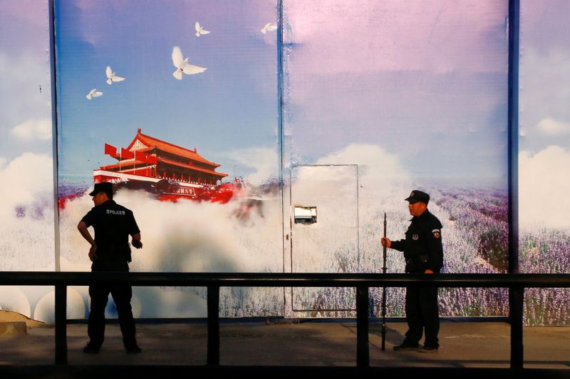 &copy; Reuters. FILE PHOTO: Security guards stand at the gates of what is officially known as a vocational skills education centre in Huocheng County in Xinjiang Uighur Autonomous Region, China September 3, 2018. REUTERS/Thomas Peter