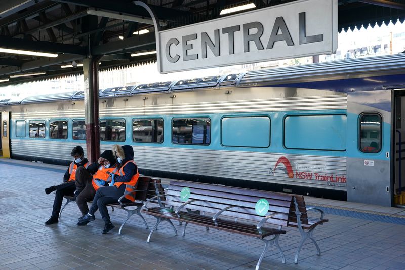 &copy; Reuters. Transport workers sit together on a train platform devoid of passengers at Central Station in the city centre as the City of Sydney and three adjacent local government areas begin a week-long lockdown to curb an outbreak of the coronavirus disease (COVID-