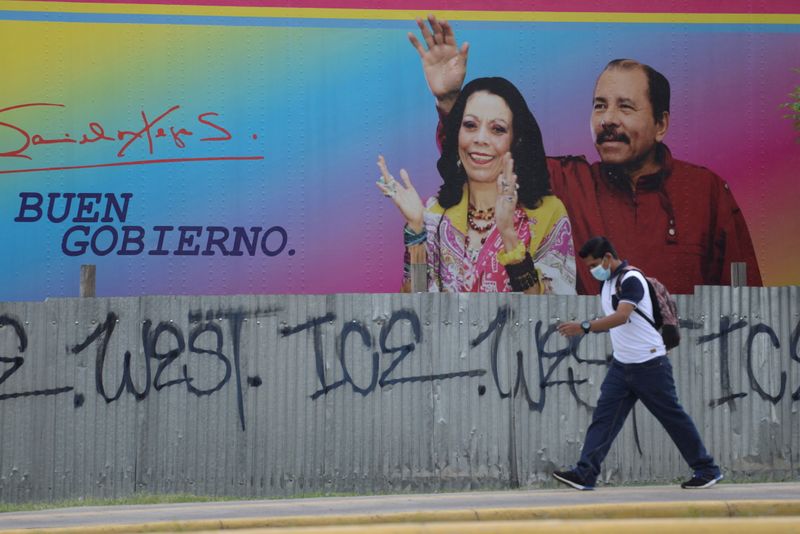© Reuters. FILE PHOTO: A man walks by a billboard showing Nicaragua's President Daniel Ortega and Vice President Rosario Murillo in Managua, Nicaragua June 21, 2021. Picture taken June 21, 2021. REUTERS/Stringer