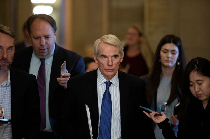 &copy; Reuters. FILE PHOTO: Senator Rob Portman (R-OH) walks along news reporters before attending a vote, on Capitol Hill in Washington, U.S., June 23, 2021.  REUTERS/Tom Brenner