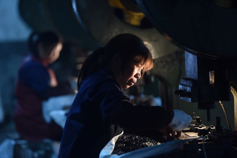 &copy; Reuters. Employees work on a production line manufacturing metal parts for furniture at a factory in Hangzhou, Zhejiang province, China April 30, 2020. China Daily via REUTERS/Files