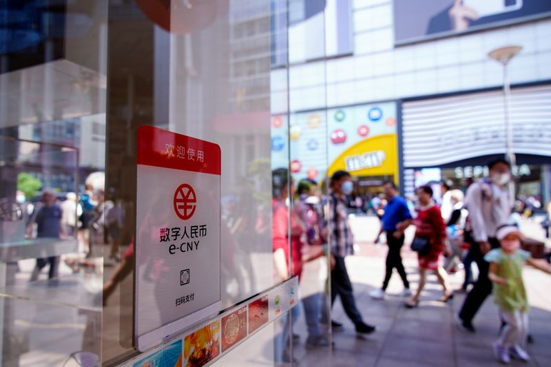 &copy; Reuters. FILE PHOTO: A sign indicating digital yuan, also referred to as e-CNY, is pictured at a shopping mall in Shanghai, China May 5, 2021. REUTERS/Aly Song