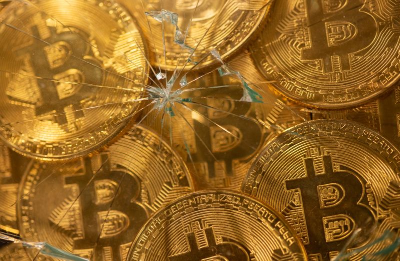 &copy; Reuters. Representations of virtual currency bitcoin are seen through broken glass in this illustration taken June 25, 2021. REUTERS/Dado Ruvic/Illustration/File Photo