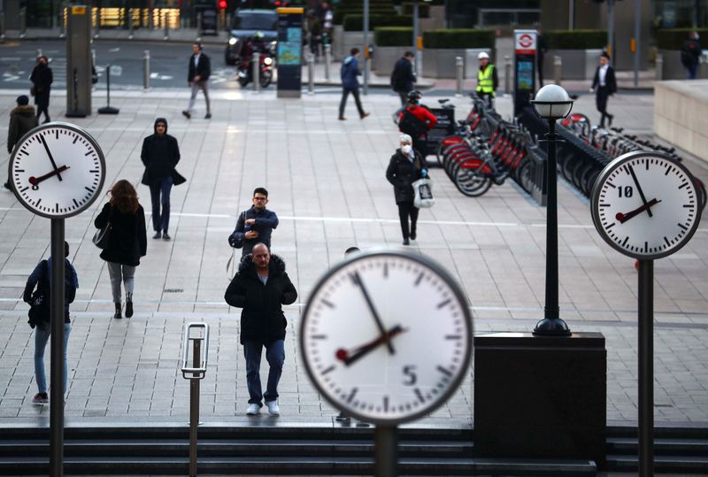 &copy; Reuters. People walk during the morning rush hour in the Canary Wharf amid the outbreak of the coronavirus disease (COVID-19) in London Britain, October 15, 2020. REUTERS/Hannah McKay