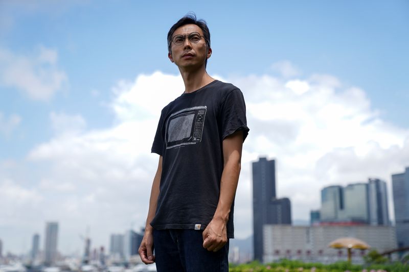 © Reuters. Documentary filmmaker Kiwi Chow, 42, poses for a photograph at Kwun Tong Ferry Pier near his studio in Hong Kong, China, June 18, 2021. Clearing the Lennon Walls was the beginning of 