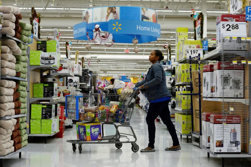 &copy; Reuters. FILE PHOTO: A customer pushes her shopping cart through the aisles at a Walmart store in the Porter Ranch section of Los Angeles November 26, 2013. REUTERS/Kevork Djansezian