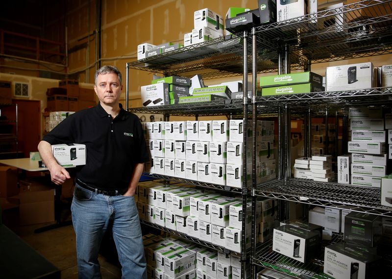 &copy; Reuters. FILE PHOTO: Bernie Thompson of Plugable Technologies holds a docking station that he sells on Amazon.com from his facility in Redmond, Washington, U.S., February 6, 2020. Picture taken February 6, 2020. REUTERS/Lindsey Wasson/File Photo