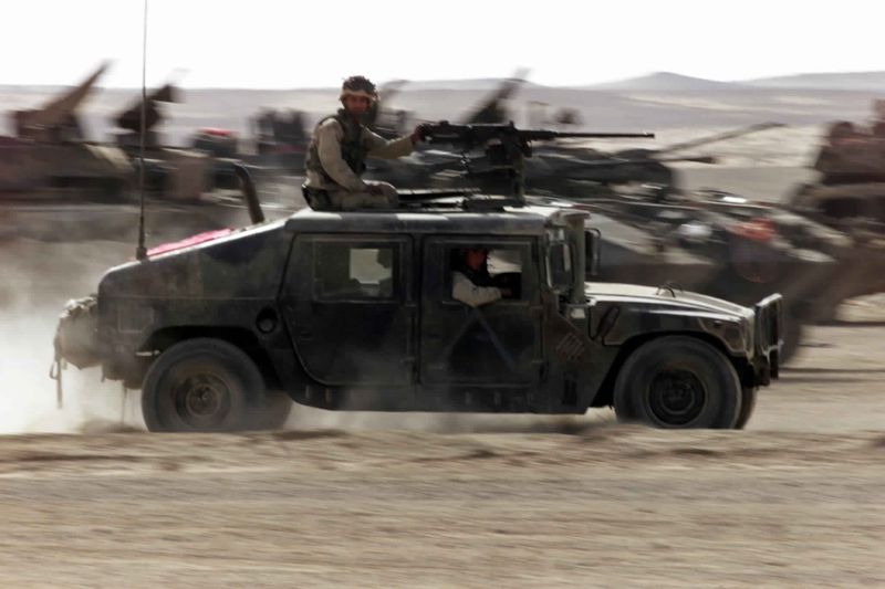 © Reuters. صورة من أرشيف رويترز لسيارات همفي تابعة للبحرية الأمريكية أثناء دورية في جنوب أفغانستان.