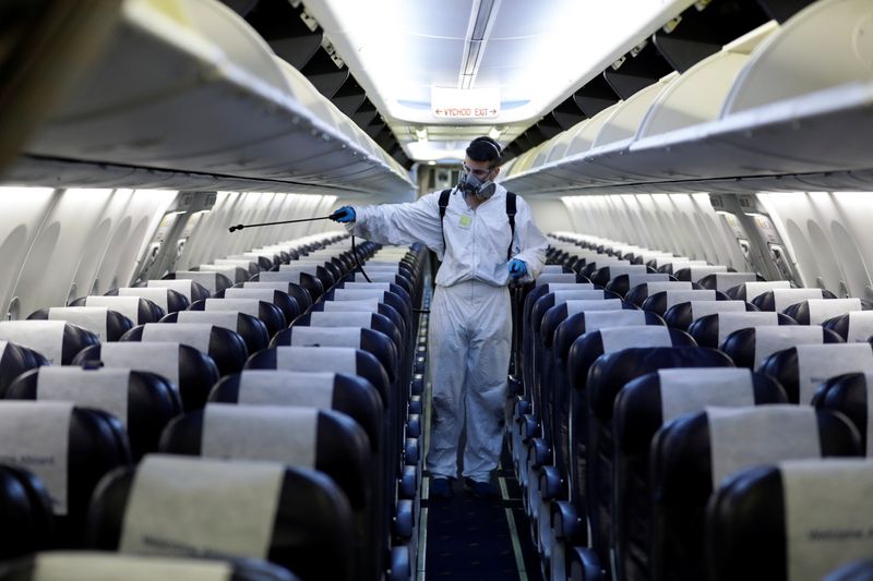 &copy; Reuters. A worker in a protective suit disinfects a passenger plane of Smartwings airline at Vaclav Havel Airport due to the coronavirus disease (COVID-19) concerns in Prague, Czech Republic, May 21, 2020. REUTERS/David W Cerny