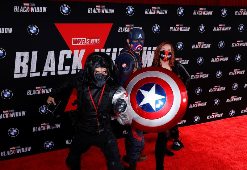 © Reuters. People dressed as Avengers characters pose as they attend a fan event and special screening of the film 