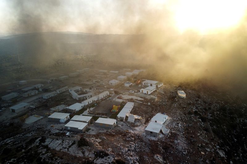 &copy; Reuters. An aerial view shows Givat Eviatar, a new Israeli settler outpost, as smoke from fires lit in the Palestinian village of Beita, drifts above, in the Israeli-occupied West Bank June 23, 2021. REUTERS/Amir Cohen