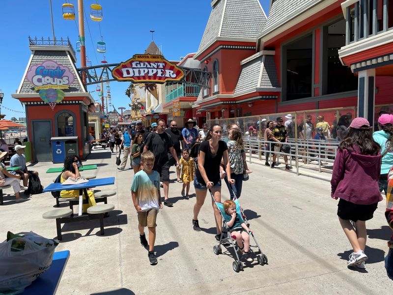 &copy; Reuters. People walk past the Giant Dipper rollercoaster ride at the Santa Cruz Beach Boardwalk, amid the coronavirus disease (COVID-19) outbreak, in Santa Cruz, California, U.S. June 28, 2021. REUTERS/Nathan Frandino